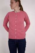half british lambswool crew neck cardigan in pink, worn buttoned to the neck showing the soft knit texture