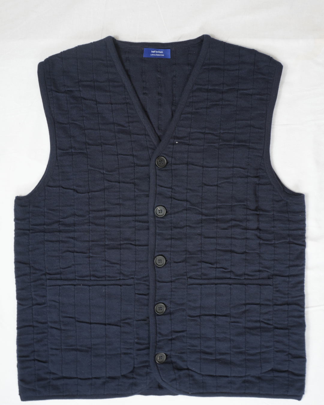 half british cotton quilted knitted gilet in navy, front view laid flat