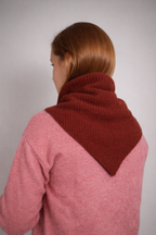 half british lambswool ribbed triangle scarf in rust, draped over the shoulders showing the ribbed knit texture