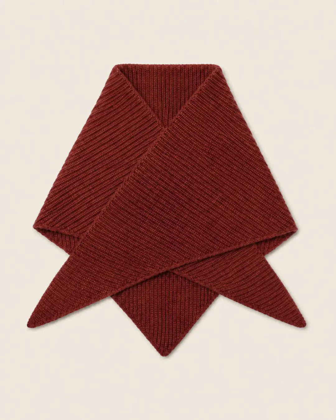 A folded ribbed knit scarf in a deep burgundy red, displayed on a light beige background.