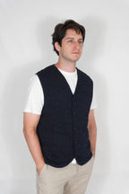 half british cotton quilted knitted gilet in navy, side view worn over a white t-shirt
