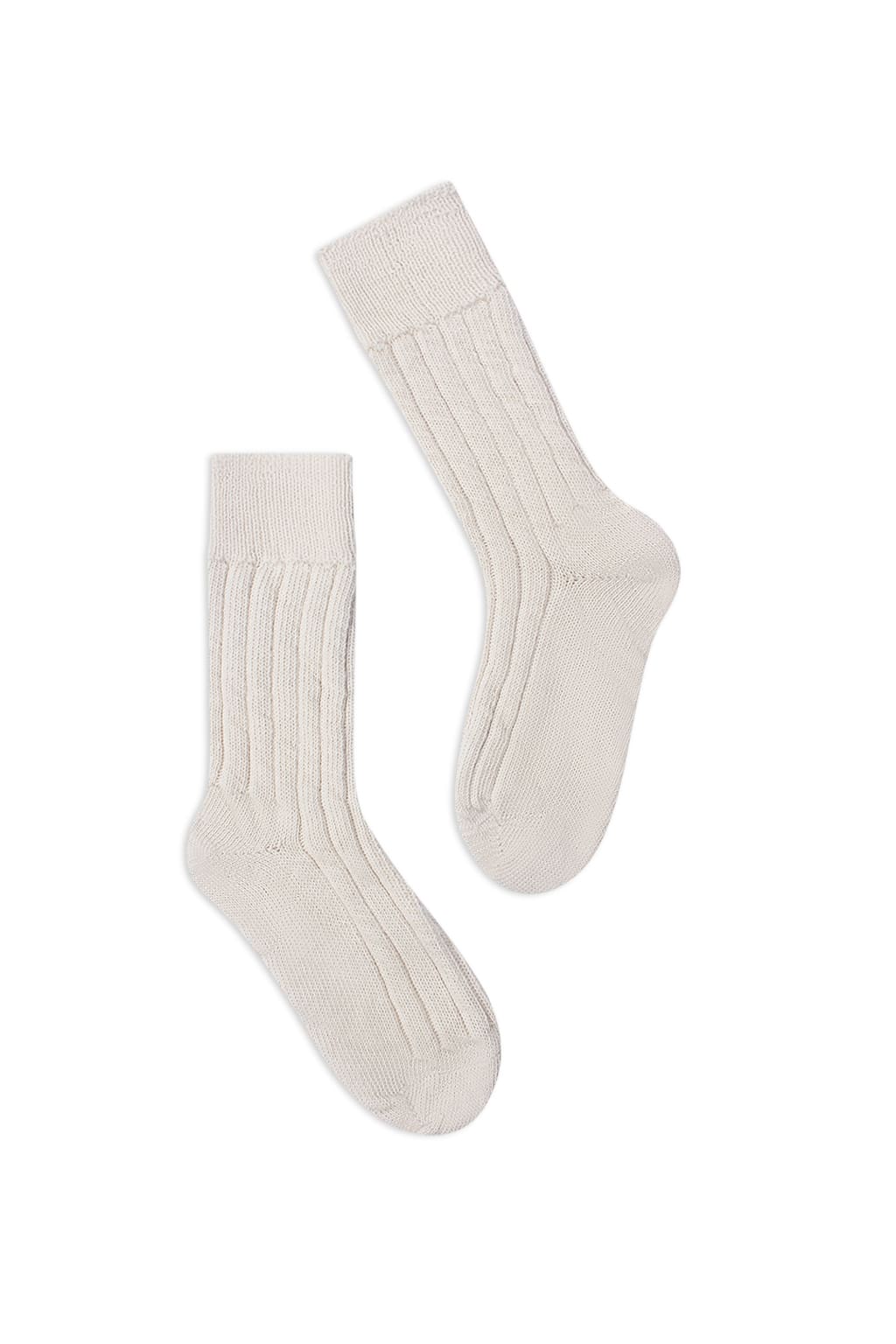 half british alpaca lounge socks in cream, pair laid flat on a background to highlight the ribbed knit structure and soft alpaca texture