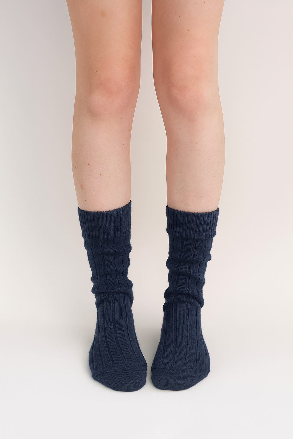 half british alpaca lounge socks in navy, worn front-facing to display the ribbed knit and soft alpaca texture against a clean background