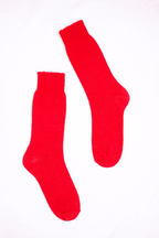 half british everyday alpaca socks in red, pair laid flat on a background showing the soft alpaca wool texture and refined ribbed knit