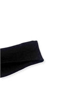 half british everyday alpaca sock in black, folded on a background highlighting its fine ribbed texture and soft alpaca wool finish