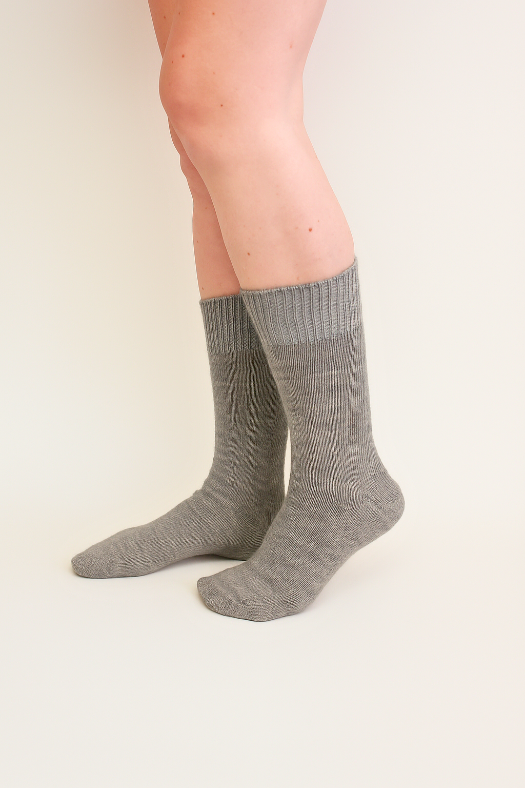 half british everyday alpaca socks in light grey, worn to show the fine ribbed knit and soft alpaca wool texture against a neutral background