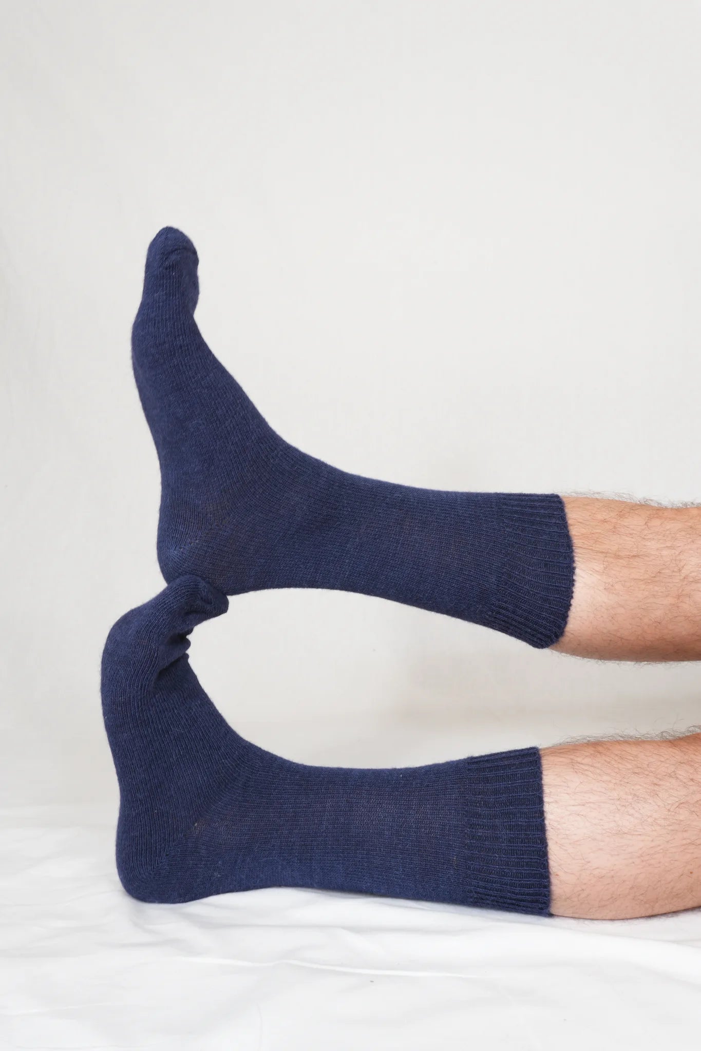 half british everyday alpaca socks in navy, worn on foot showing the fine ribbed knit and soft alpaca wool texture